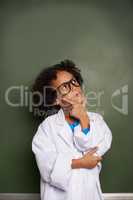 Dreaming of his bright future. An ethnic boy wearing glasses and a lab coat looking contemplative - copyspace.