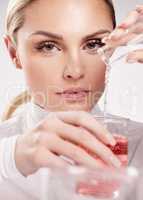 True beauty comes from within and is seen outwardly. Studio shot of young woman making a potion against a white background.