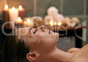 Being pampered from top to toe. A young woman lying with her eyes closed on a massage bed.