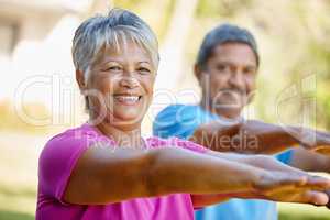 Living life with vitality. Portrait of a mature couple exercising together in their backyard.