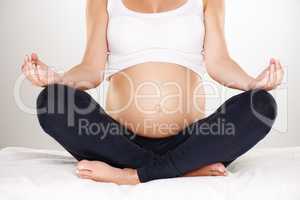 Two souls connected. Cropped shot of a pregnant woman meditating in the lotus position.