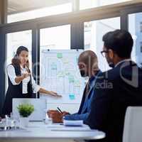 Even you can agree that this will boost productivity. Shot of a young businesswoman giving a demonstration on a white board to her colleagues in a modern office.