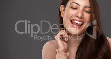 True beauty comes from being yourself. Cropped shot of an attractive young woman making a face in studio against a grey background.