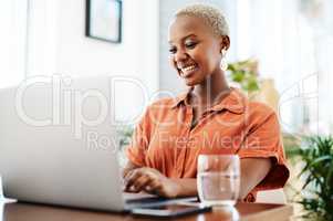 She holds outstanding practices in managing her business. Shot of a young businesswoman working on a laptop in an office.