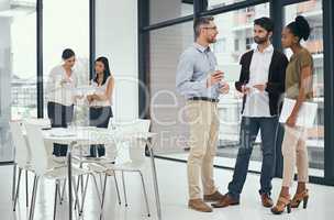 The biggest assurance of success is teamwork. Shot of a group of colleagues having a discussion in an office.