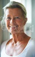 Living life with a positive outlook. Attractive elderly woman looking at you with a smile.