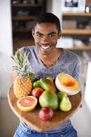 Ive got the best of everything. Shot of a handsome young man proudly showing off his fresh produce.