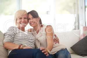 We live a a life of love. Portrait of a lesbian couple relaxing at home.