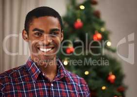 Christmas is my favourite time of year. Shot of a handsome young man getting into the Christmas spirit.