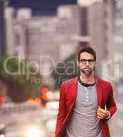 Walking the streets in style. Shot of a handsome young man taking a walk through the city.