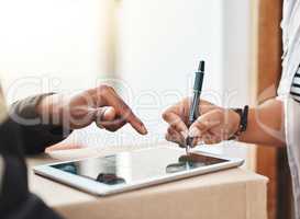 Its all gone electronic now. Closeup shot of an unrecognizable woman using a digital tablet to sign for her delivery from the courier.