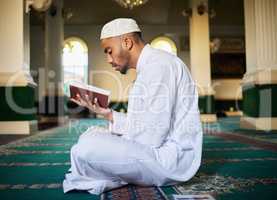 Do not lose hope, nor be sad. Shot of a young muslim male reading scripture in a mosque.