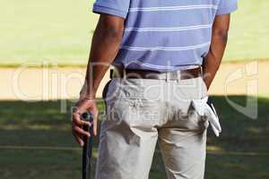Waiting for his tee-off. Rearview cropped shot of a golfer midsection with a glove hanging out of his back pocket.
