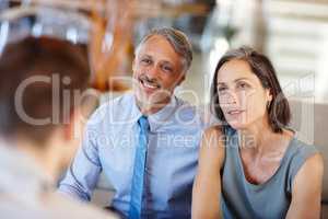 Theyre a great team - in life AND business. A cropped shot of a mid adult couple having a meeting with a young businessman.