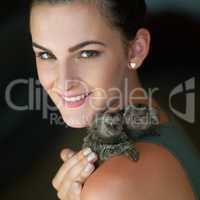 Theyre my little fur babies. Cropped portrait of an attractive young woman posing with two pigmy marmosets.