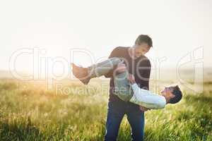 Adding tons of fun to their time together. Shot of a father and son having fun together outdoors.