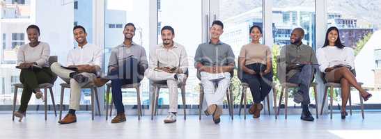 Future leaders. Shot of a group of people waiting to be interviewed for a job at a modern office.