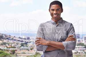 Hes got the ambition to succeed. Portrait of a handsome young man standing against a city backdrop.