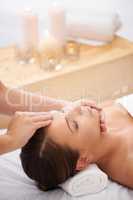 Blissful pampering. A young woman lying in a health spa getting pampered.