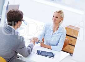 Congratulations, youre top of the team. Shot of a positive businesswoman shaking hands with a male staff member.