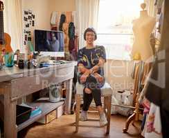 She draws inspiration from her surroundings. Portrait of a stylish young designer sitting in her eclectic studio.