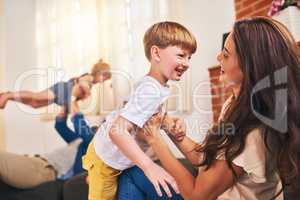 First rule of family time, have lots of fun. Shot of a happy young family enjoying playtime together at home.