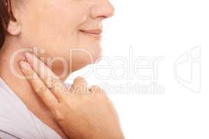Checking on her pulse rate. Mature woman taking her pulse rate against a white background.