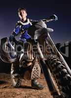 Hes the poster boy for dirtbiking. Portrait of a young motocross rider posing on his bike.