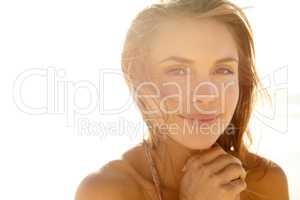 Blissful summer moments. Cropped portrait of a gorgeous young woman in the sunlight on the beach.