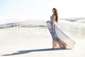 Freedom and isolation on the beach. Shot of a beautiful young woman on the beach.