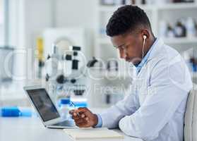 Research has no substitute. Cropped shot of a focused young male scientist working on his laptop while being seated inside of a laboratory.