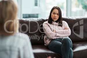 Therapy isnt for everyone. Shot of a young woman having a therapeutic session with a psychologist.