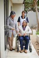 Supporting her spouse through the senior years. Shot of a senior woman and her husband with a nurse at a retirement home.