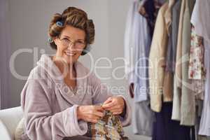 Knitting is my hobby. Full length shot of a senior woman knitting at home.