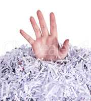 Drowning in destroyed documents. Studio shot of a womans hand reaching out from under a pile of shredded paper against a white background.