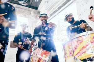 Youve got some moves. Low angle portrait of a group of handsome young male drummers playing at Carnival.