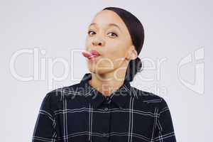 The best moments are made with a lot of humour. Studio shot of a young woman making a funny face against a gray background.