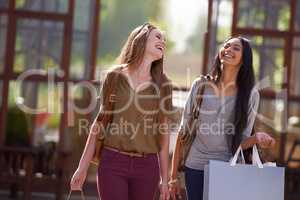 Its a great day for shopping. Two attractive young woman with their shopping bags after a day of retail therapy.