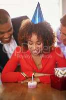 Blow out your birthday candle. Cropped shot of a group of coworkers celebrating a birthday.