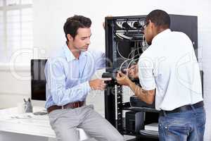 Never fear when the IT guy is near. A young IT specialist ready to fix a server.