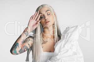 Never conform to the norm. Cropped shot of an attractive young woman posing with her eyes closed against a grey background in studio.