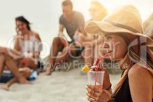 Fun guaranteed when theyre together. Shot of a group of happy young friends enjoying a picnic on the beach together.