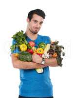 I keep good food close. Studio portrait of a handsome young man posing with a variety of fresh vegetables against a white background.