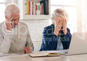 How are we going to get through all of this.... Cropped shot of a senior couple looking anxious while working on some paperwork.