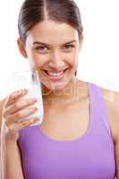 Keep calm and drink milk. Portrait of a beautiful woman holding a glass of milk.