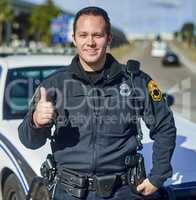 This city is safe. Cropped portrait of a handsome young policeman giving thumbs up while out on patrol.