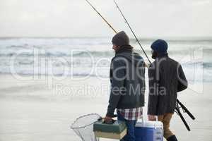 Packed and ready to fish. Shot of a two friends going fishing on an early overcast morning.