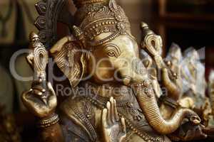 Beautifully crafted iconography. Closeup of a bronze effigy of the god Ganesha in an Indian temple.