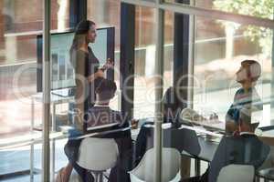 Taking stock and setting new targets. Shot of a corporate businessperson giving a presentation in the boardroom.