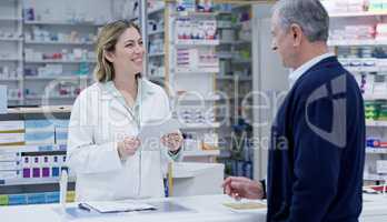 Always ready to deliver the best solutions to you. Shot of a young pharmacist handing out a prescription to a senior citizen at a pharmacy.